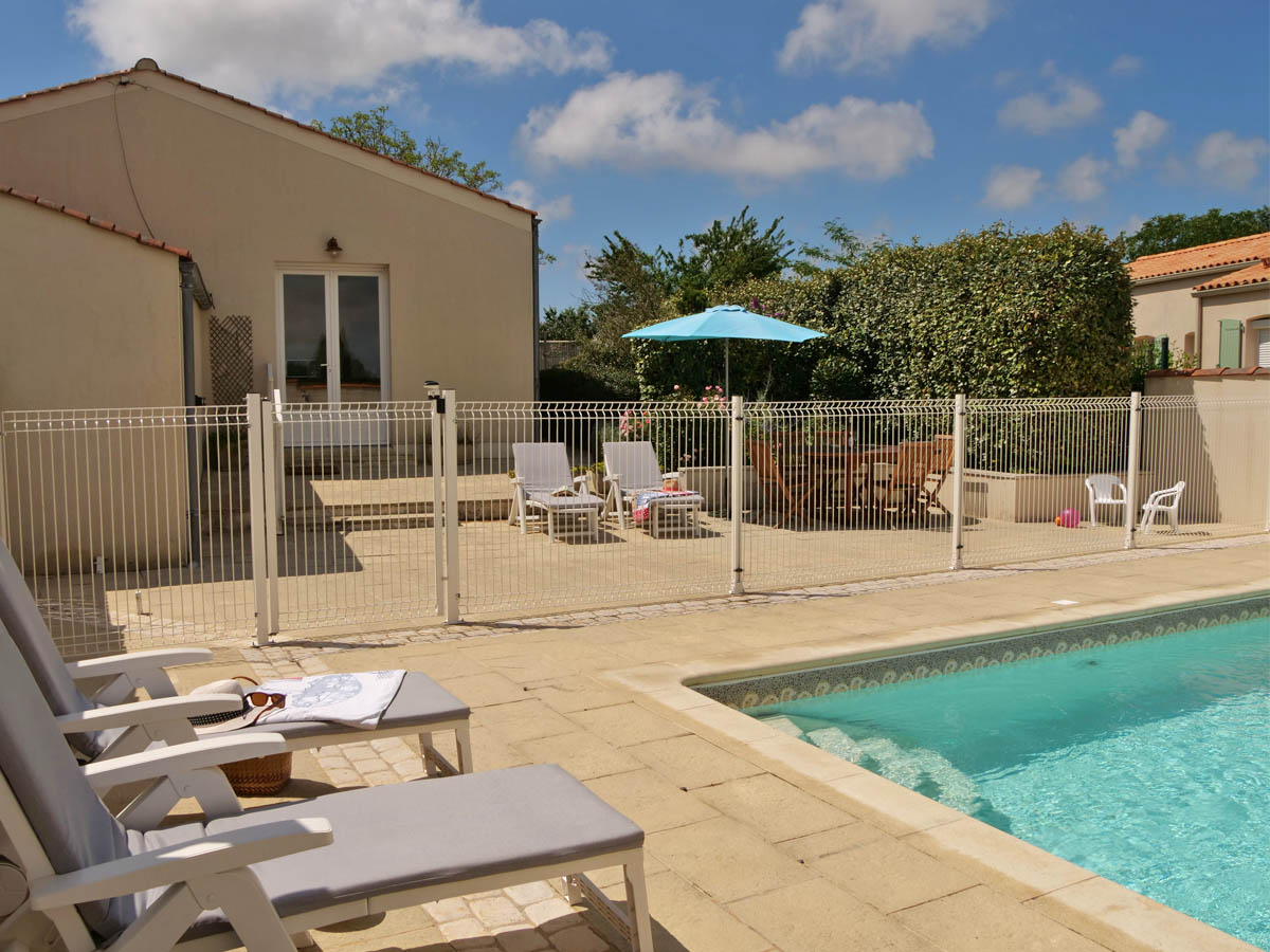 Relax by the pool at Le Petit Michelais Gite