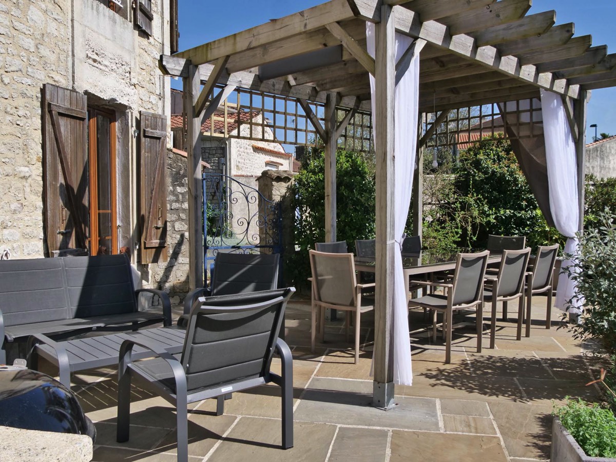 Terrace with shady pergola a seats for relaxing at Le Vieux Cafe