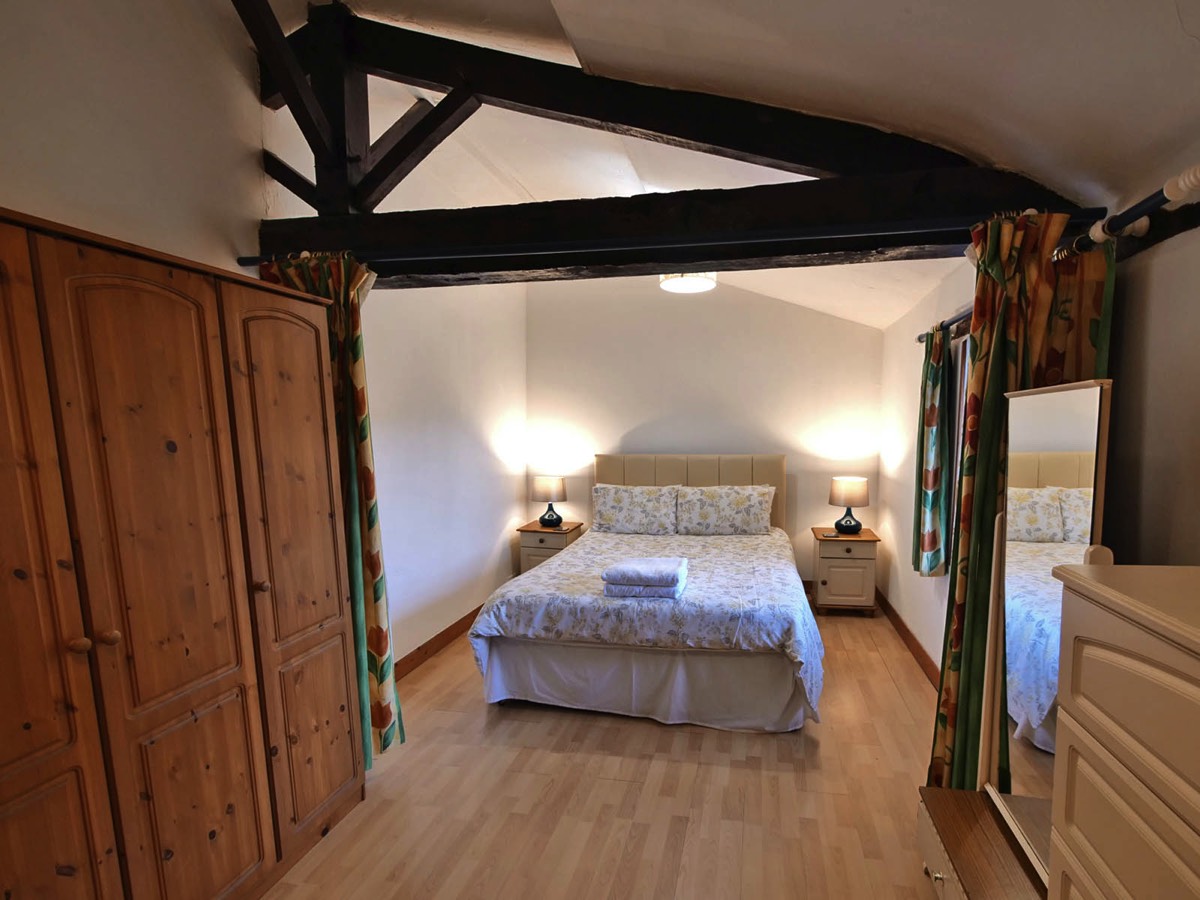 Family Bedroom with Kingsized bed at Les Poiriers Holiday Cottage